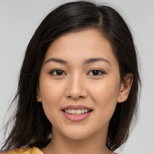 Joyful white young-adult female with long  brown hair and brown eyes