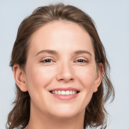 Joyful white young-adult female with medium  brown hair and grey eyes