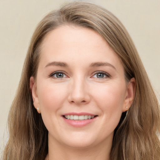 Joyful white young-adult female with long  brown hair and grey eyes