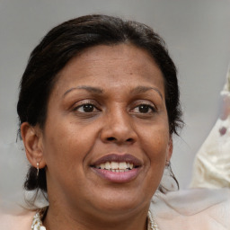 Joyful white adult female with medium  brown hair and brown eyes