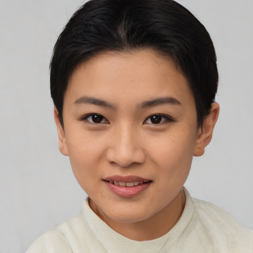 Joyful asian young-adult female with short  black hair and brown eyes