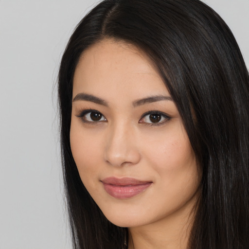 Joyful latino young-adult female with long  black hair and brown eyes