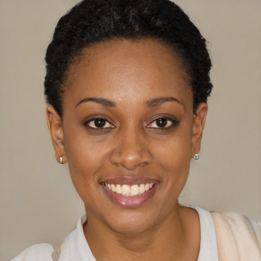 Joyful black young-adult female with short  brown hair and brown eyes