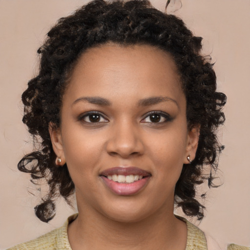 Joyful black young-adult female with medium  brown hair and brown eyes