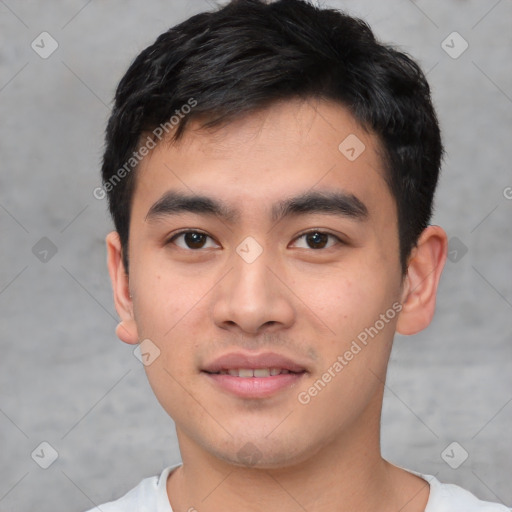 Joyful asian young-adult male with short  black hair and brown eyes