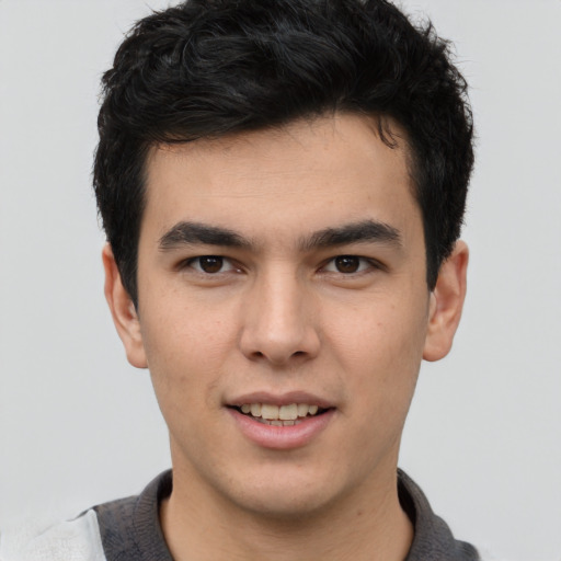 Joyful latino young-adult male with short  brown hair and brown eyes