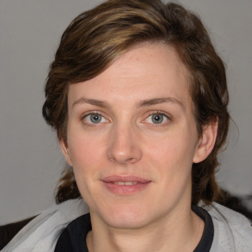 Joyful white young-adult female with medium  brown hair and blue eyes