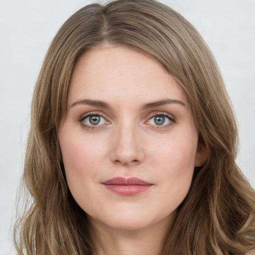 Joyful white young-adult female with long  brown hair and green eyes