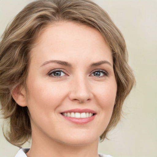 Joyful white young-adult female with medium  brown hair and green eyes