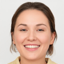 Joyful white young-adult female with medium  brown hair and brown eyes