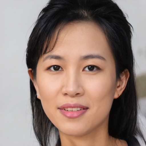 Joyful asian young-adult female with medium  brown hair and brown eyes
