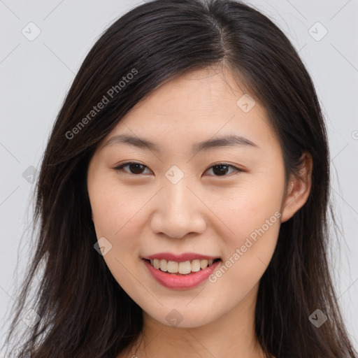 Joyful asian young-adult female with long  brown hair and brown eyes