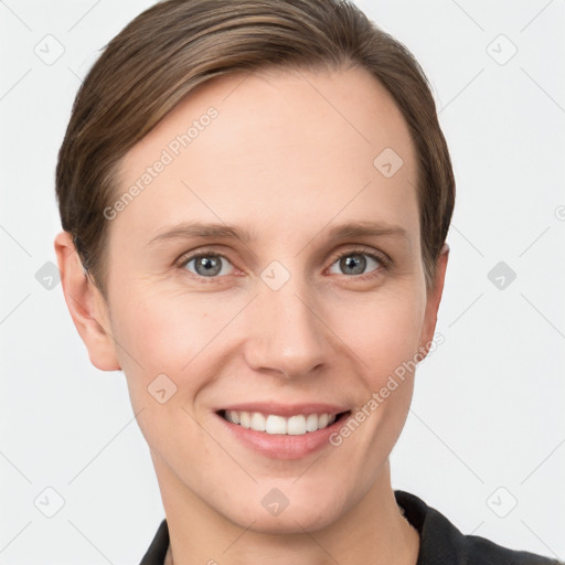 Joyful white young-adult female with short  brown hair and grey eyes