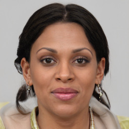 Joyful black adult female with medium  brown hair and brown eyes