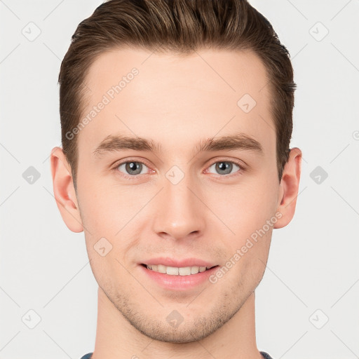 Joyful white young-adult male with short  brown hair and grey eyes