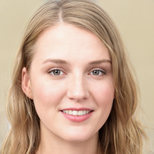 Joyful white young-adult female with long  brown hair and grey eyes