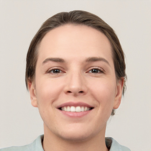 Joyful white young-adult female with short  brown hair and brown eyes