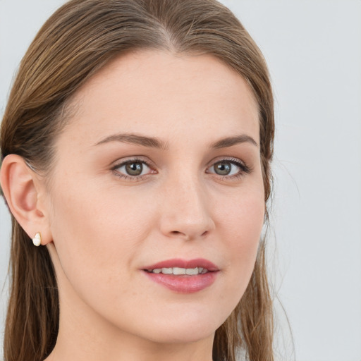 Joyful white young-adult female with long  brown hair and blue eyes