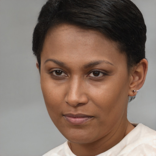 Joyful black young-adult female with short  brown hair and brown eyes