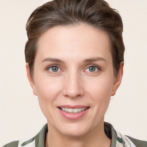 Joyful white young-adult female with short  brown hair and grey eyes