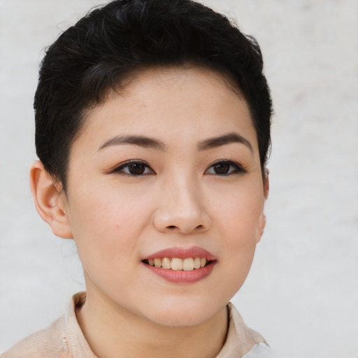 Joyful asian young-adult female with short  brown hair and brown eyes