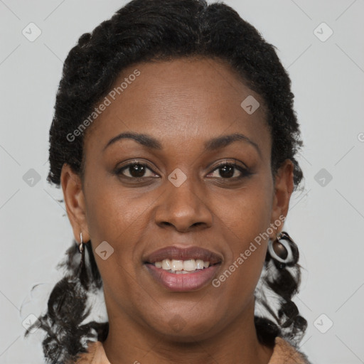 Joyful black adult female with short  brown hair and brown eyes