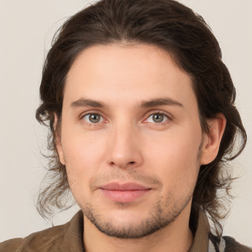 Joyful white young-adult male with medium  brown hair and brown eyes