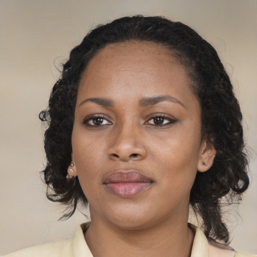Joyful black young-adult female with medium  black hair and brown eyes