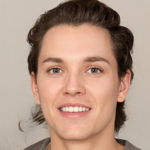 Joyful white young-adult male with medium  brown hair and brown eyes