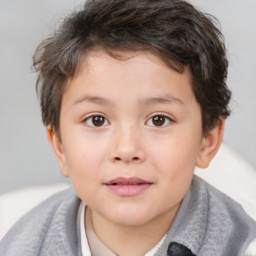 Joyful white child male with short  brown hair and brown eyes