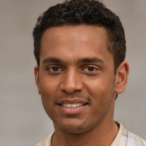 Joyful white young-adult male with short  brown hair and brown eyes