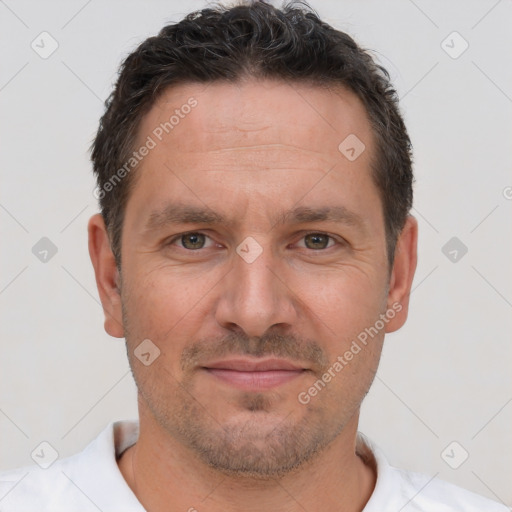 Joyful white adult male with short  brown hair and brown eyes