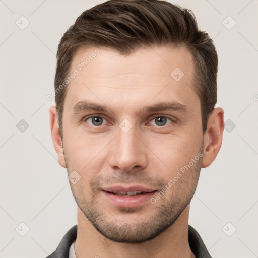 Joyful white young-adult male with short  brown hair and grey eyes