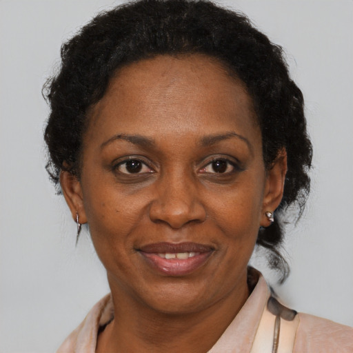 Joyful black adult female with short  brown hair and brown eyes