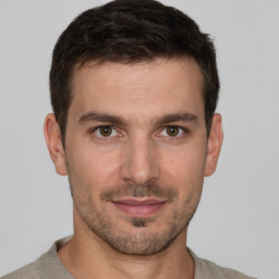 Joyful white young-adult male with short  brown hair and brown eyes