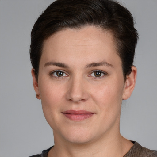 Joyful white young-adult female with short  brown hair and grey eyes