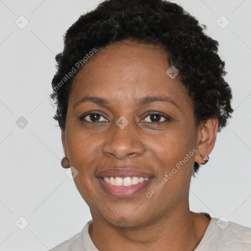 Joyful black adult female with short  brown hair and brown eyes