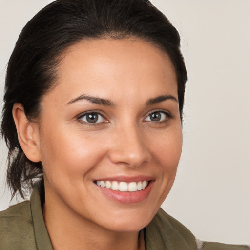 Joyful white young-adult female with medium  brown hair and brown eyes