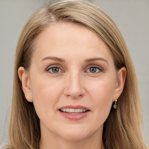 Joyful white adult female with long  brown hair and brown eyes