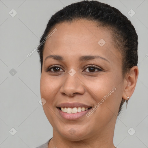 Joyful black young-adult female with short  brown hair and brown eyes