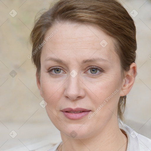 Joyful white adult female with medium  brown hair and blue eyes