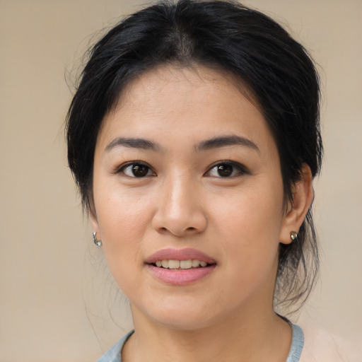 Joyful asian young-adult female with medium  brown hair and brown eyes