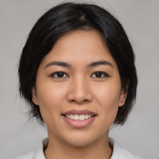 Joyful asian young-adult female with medium  brown hair and brown eyes