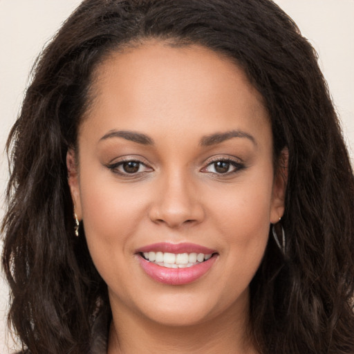 Joyful white young-adult female with long  brown hair and brown eyes