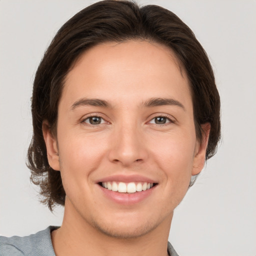 Joyful white young-adult female with short  brown hair and brown eyes