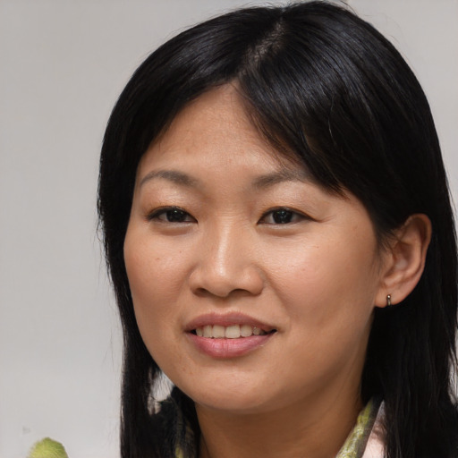 Joyful asian young-adult female with medium  brown hair and brown eyes