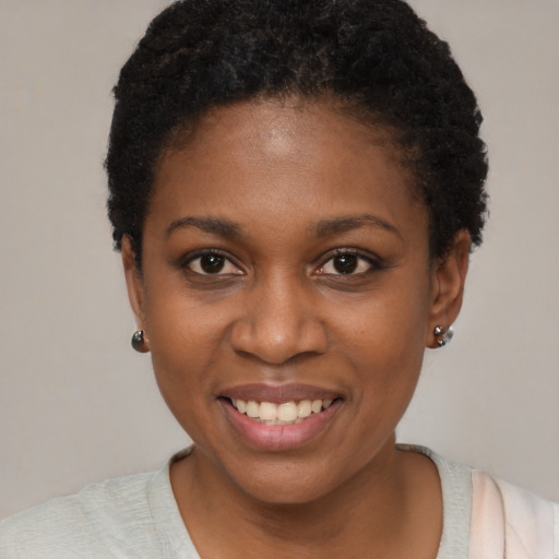 Joyful black young-adult female with short  brown hair and brown eyes