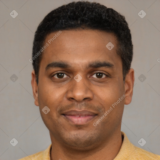 Joyful black young-adult male with short  black hair and brown eyes