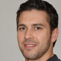 Joyful white adult male with short  brown hair and brown eyes