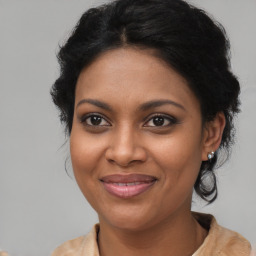 Joyful black young-adult female with medium  brown hair and brown eyes